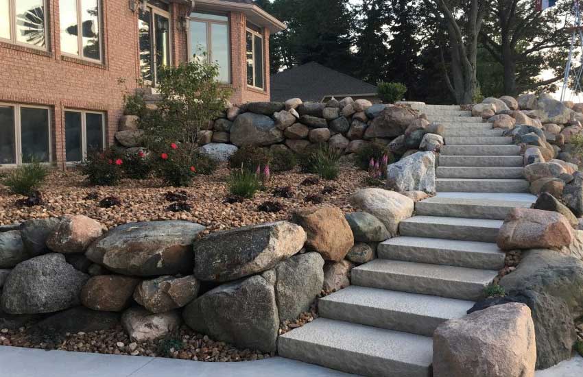 Boulder retaining wall design and construction by Landscapes Unlimited in Minnesota