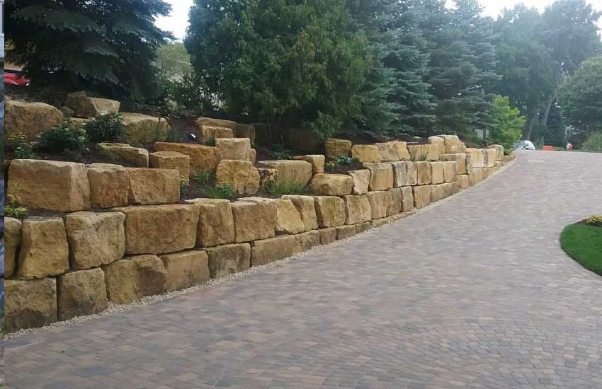 Boulder retaining wall design and construction by Landscapes Unlimited in Minnesota