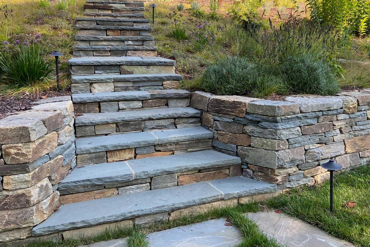 Fieldstone retaining wall design by Landscapes Unlimited in Minnesota