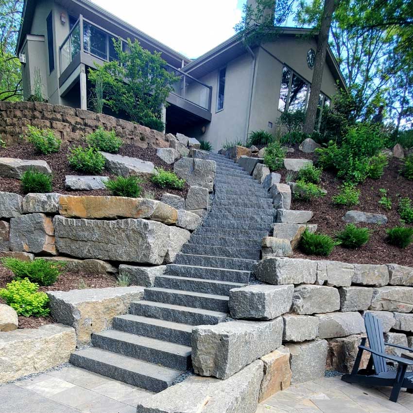Granite retaining wall design and construction by Landscapes Unlimited in Minnesota