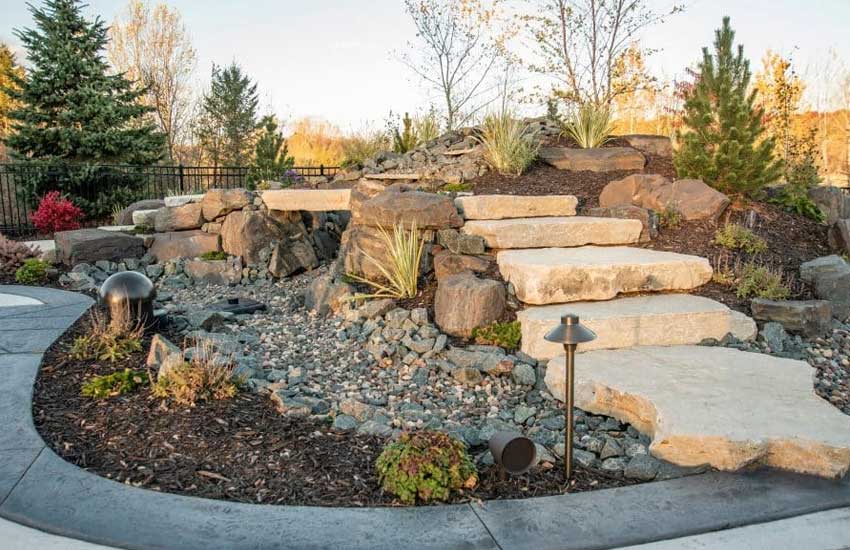 Rain garden and dry creek bed drainage solution Minnesota
