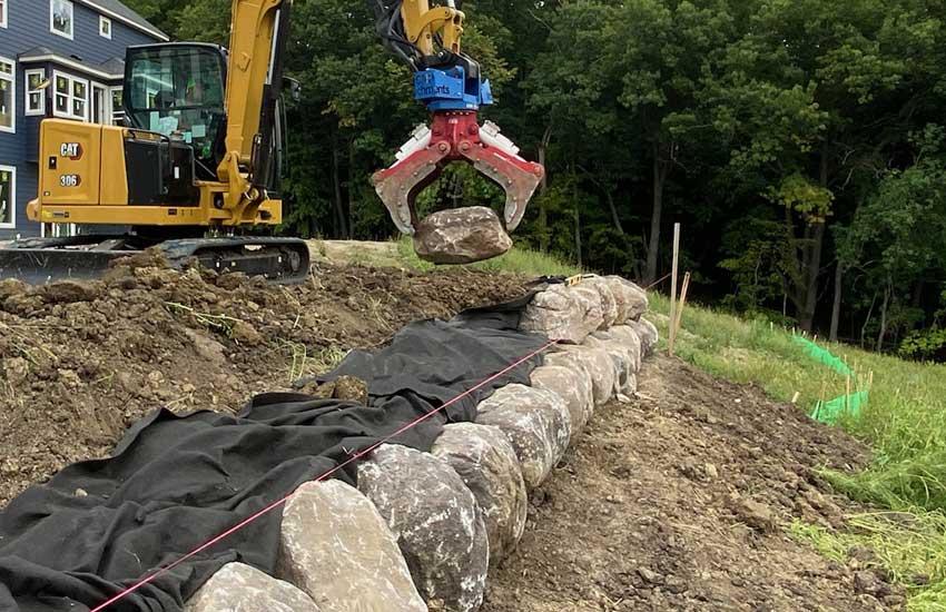 Residential boulder retaining wall landscape