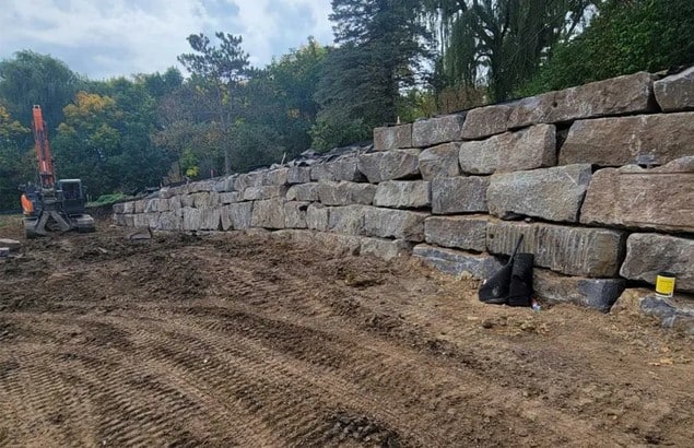 Commercial boulder retaining wall by Landscapes Unlimited