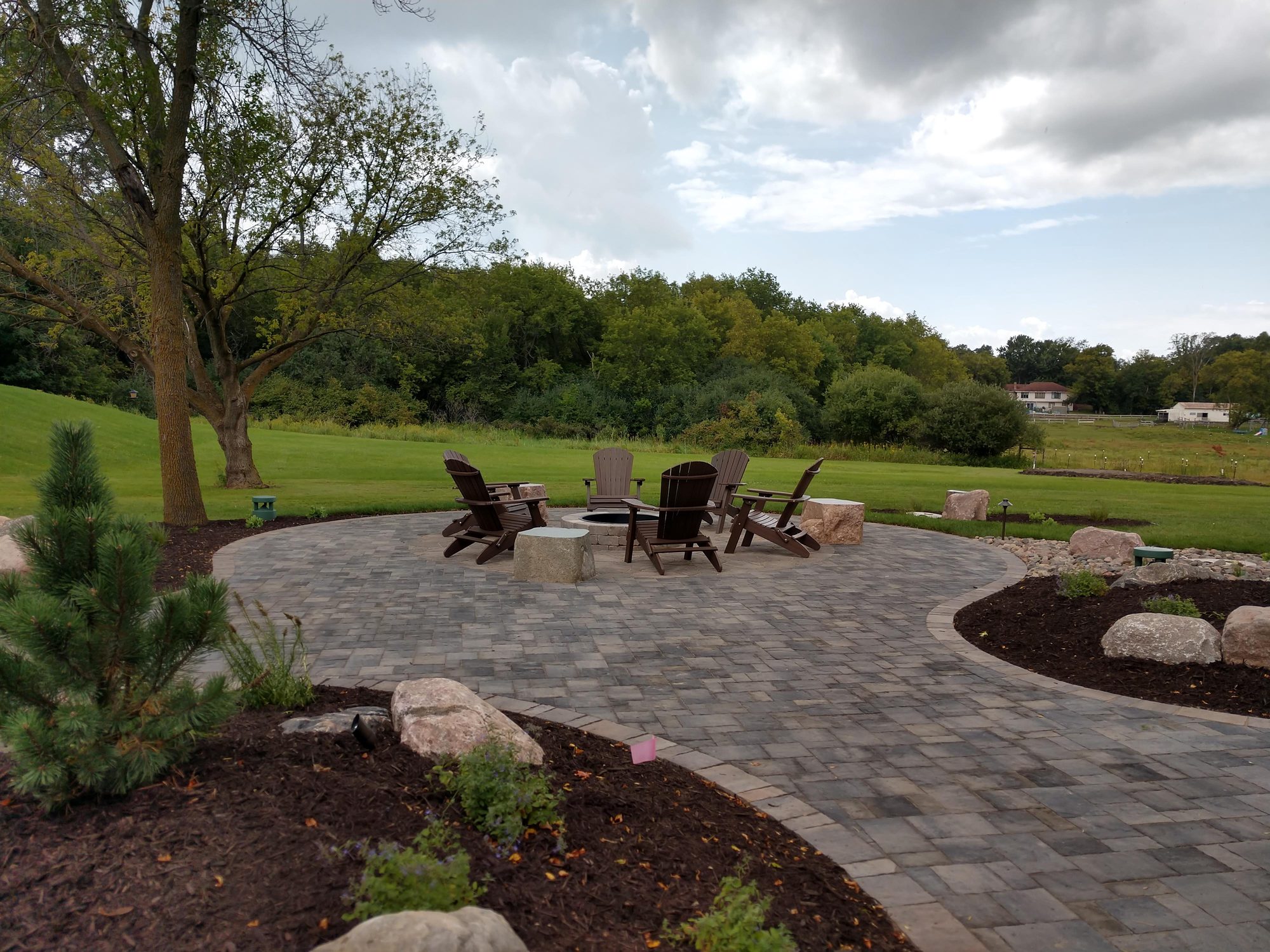 Circular paver fire pit patio and landscaping in Medina MN