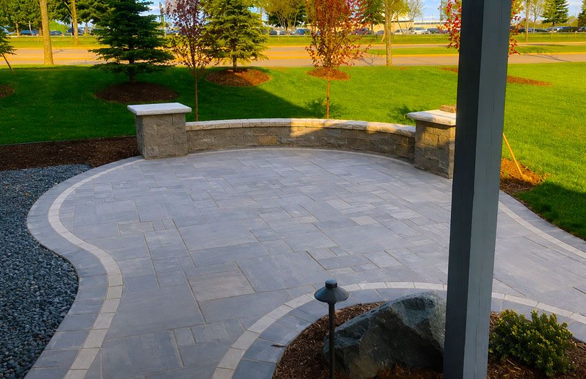 Curved paver patio with seat wall and pillars in Woodbury MN