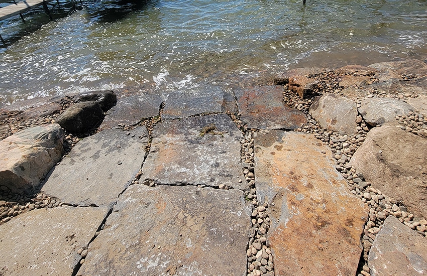 Stone shoreline erosion control with flagstone lake access and boat docks in Minnetonka, MN