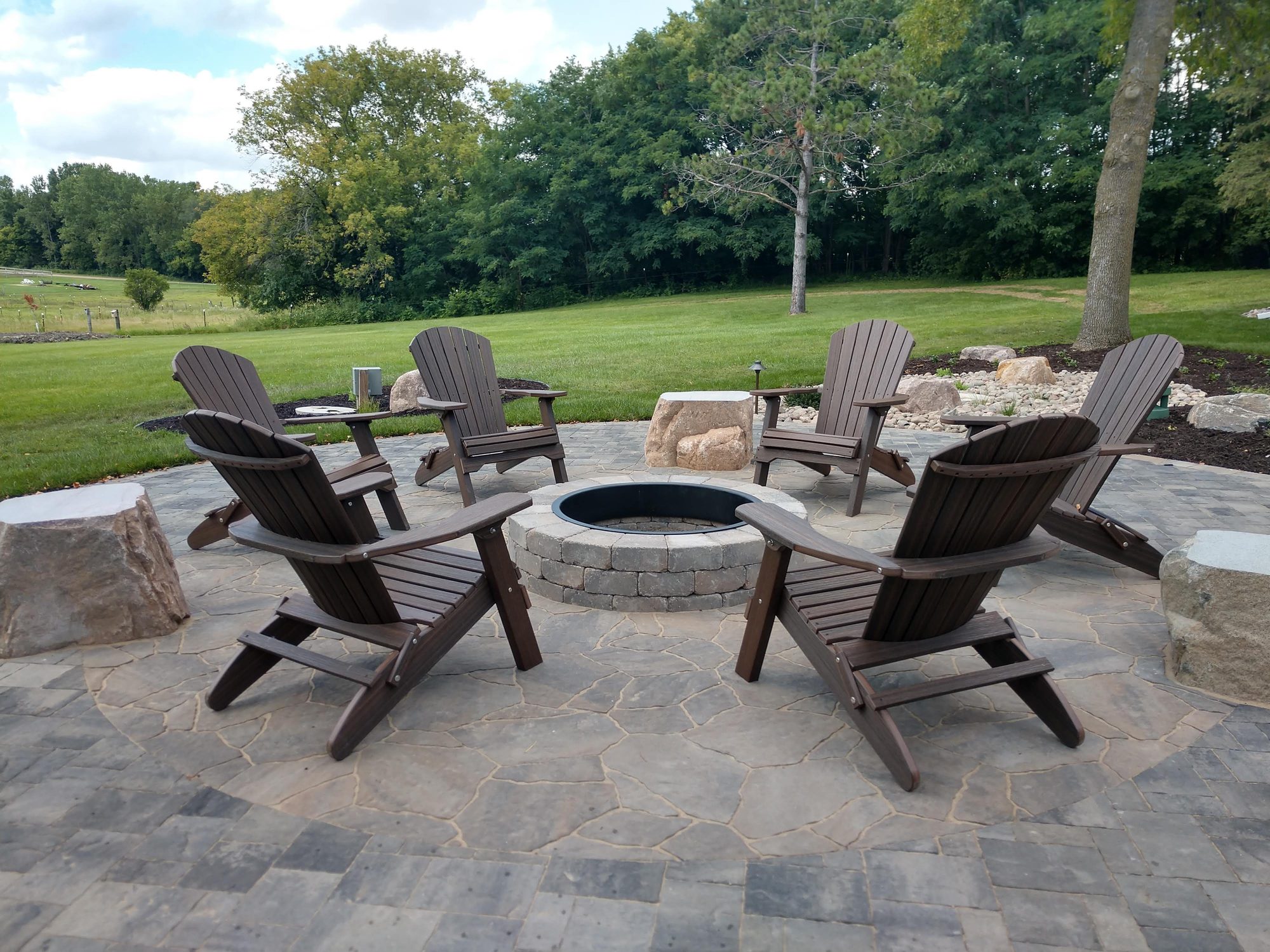 Wood burning paver fire pit with flagstone ring in Medina MN